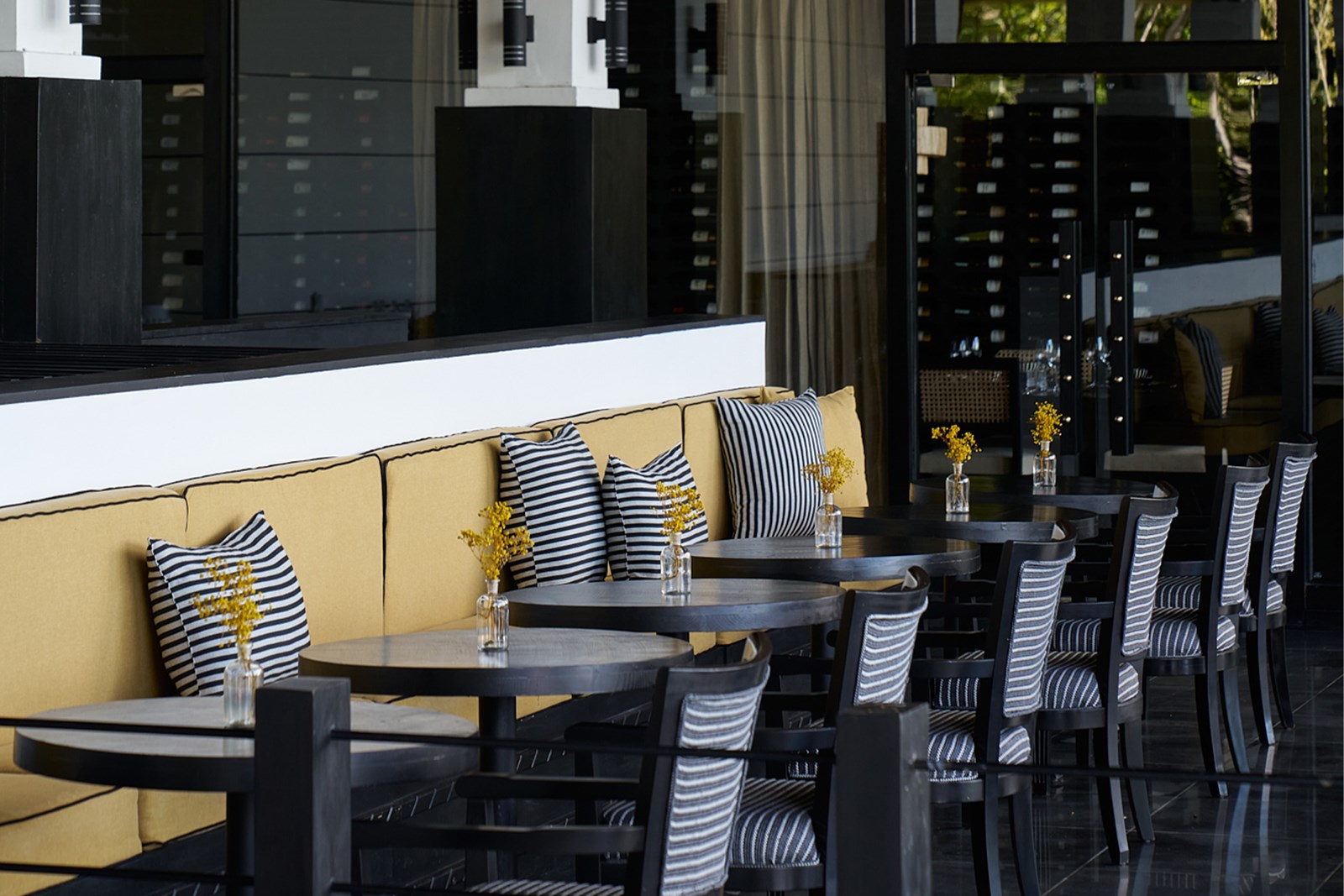 The Kitchen restaurant: banquettes with striped cushions and dark tables